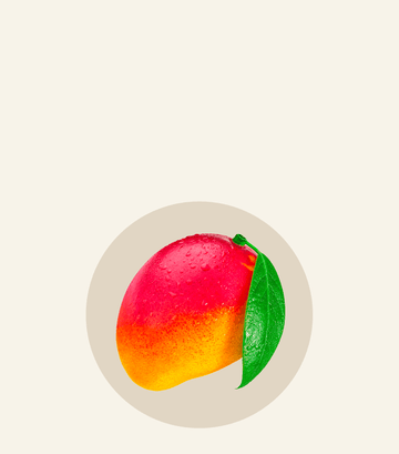 Fresh ripe mango with a vibrant orange-red hue and green leaf, featured in Oh La La recipe ingredients.